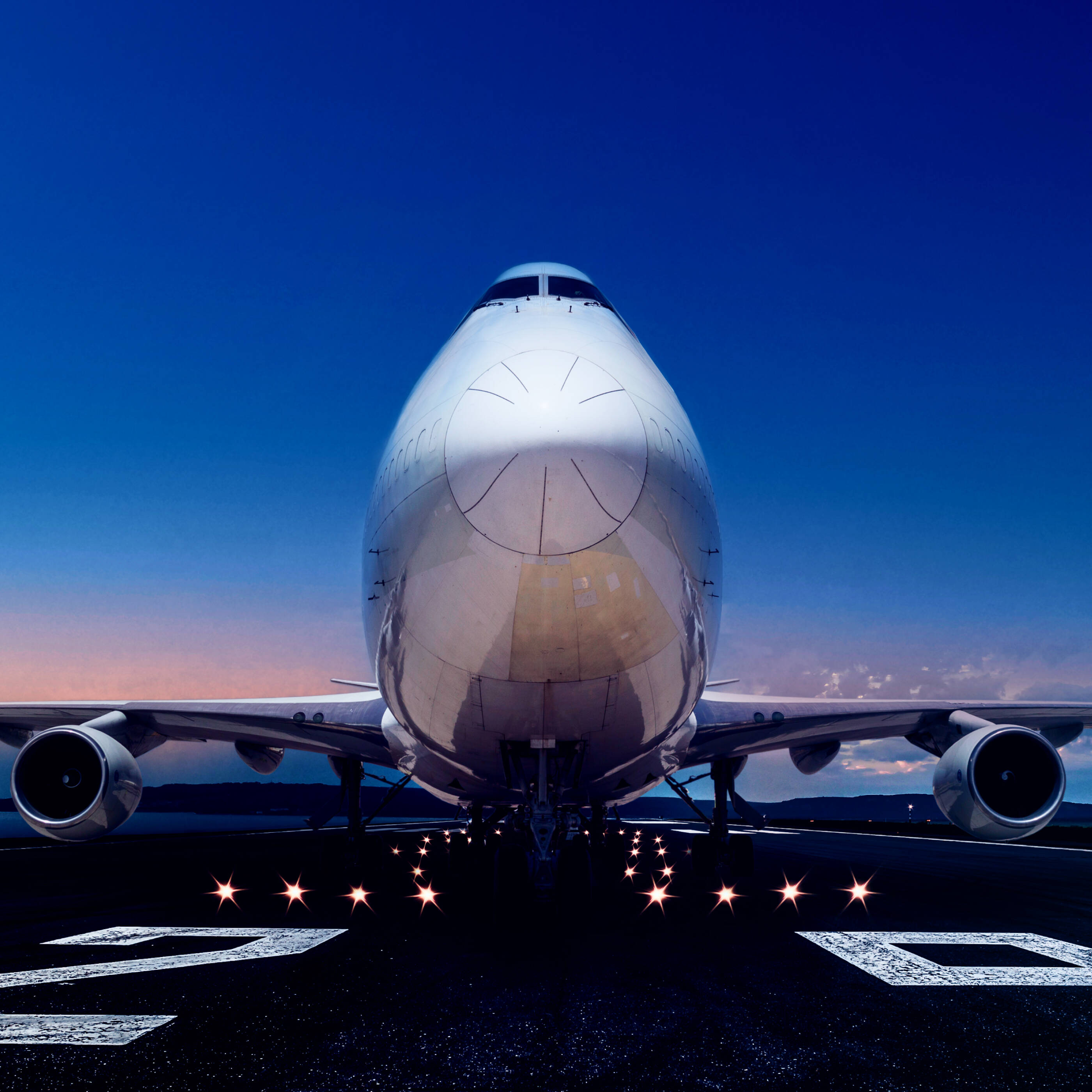 airplane on runway at dusk