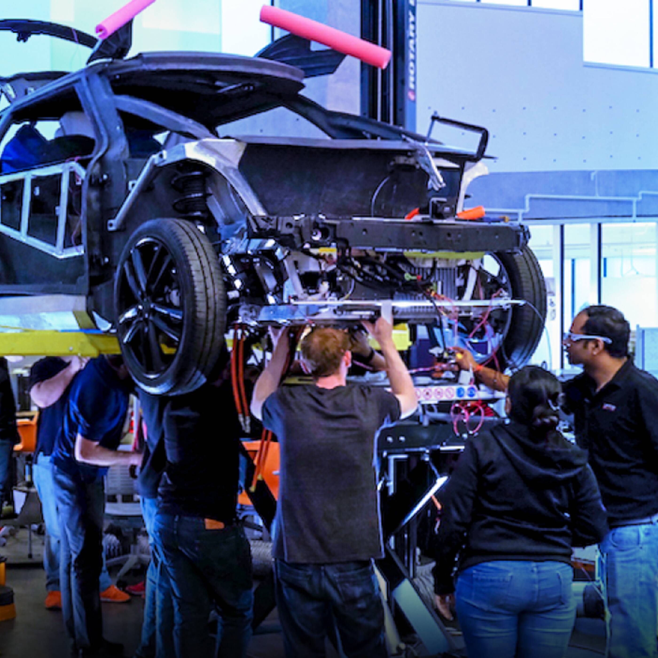 mechanics working on car frame