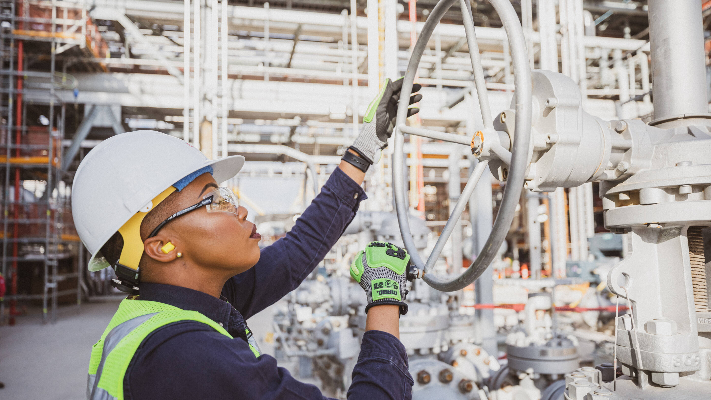 worker adjusting a valve at Baytown facility